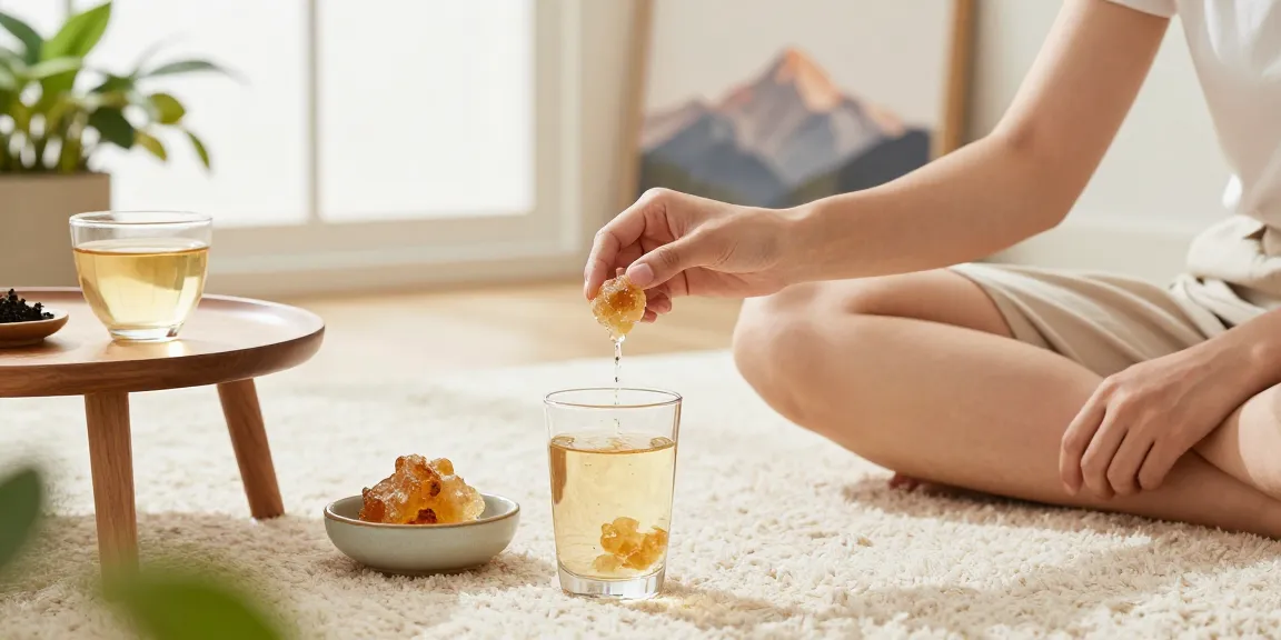 Authentic shilajit resin Australia being dissolved in warm water in a calming home setting.
